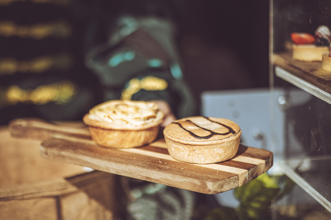 two rustic pies served up on a wooden board